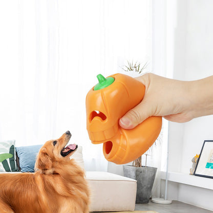 Dog playing with pumpkin treat toy